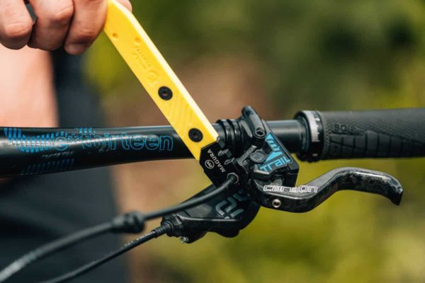 Loosening and tightening the compression sleeve nut on the brake master with the 8-Bit Tire Lever & Magura Disc Brake Tool