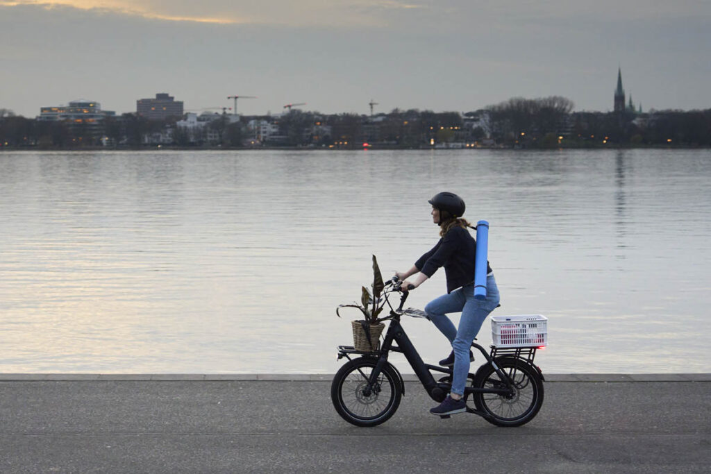 Momentum Compakt E+ ebike with baskets on the front and rear rack