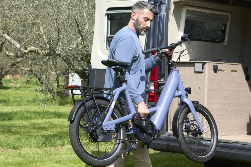 Momentum Compakt E+ 1 ebike being stowed in a motorhome