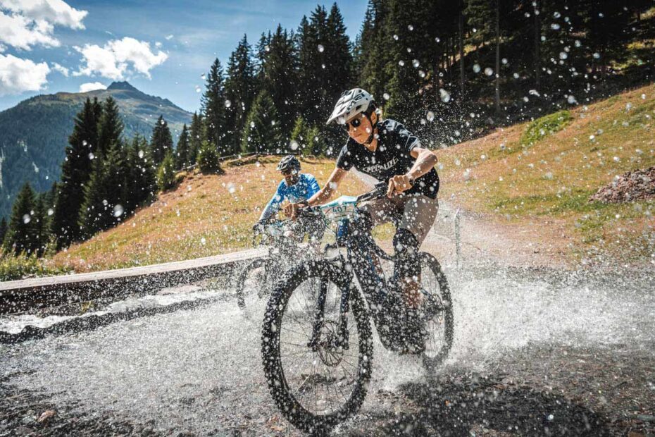 Ebike riders cross a stream at the E-Bike World Championship for Everyone.