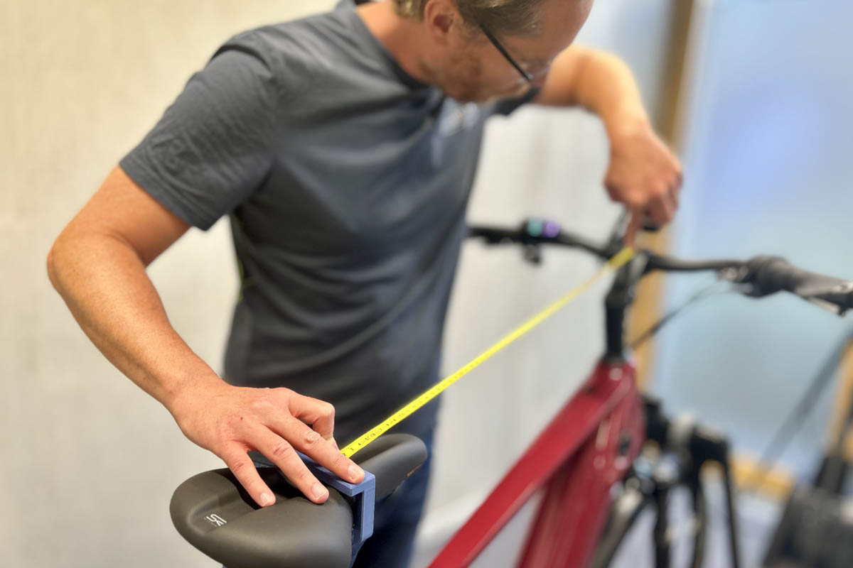 Measuring the distance between the saddle and the handlebars during a bike fitting for ebikes