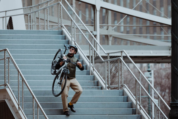 Scott Silence eRide ebike carried down a flight of stairs on shoulders