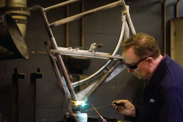 Mechanic brazing a bicycle frame